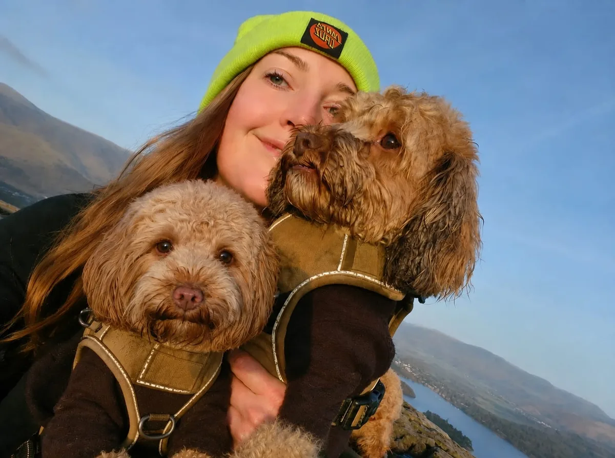 Carly with her dogs Buckley and Bowie on a hilltop